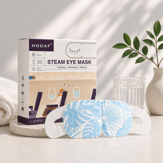 Unscented steam eye mask with product box in bright clean setting with glass of water and natural light