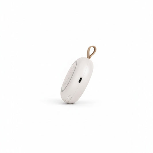 SlumberHush SoundCore baby sleep machine, white portable sound device with tan loop and USB-C port.