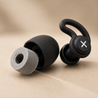 Close-up of black ergonomic sleep earbud with removable soft foam tip showing in-ear comfort design