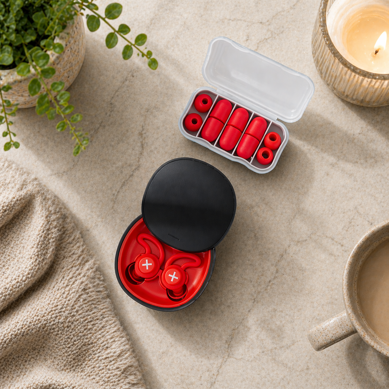 Red wireless in-ear sleep earbuds in open charging case with multiple ear tips arranged in tray on warm neutral background