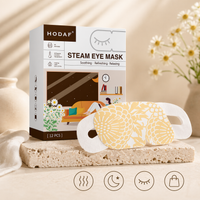 Chamomile steam eye mask with product box in soft daylight setting with flowers and minimal lifestyle elements