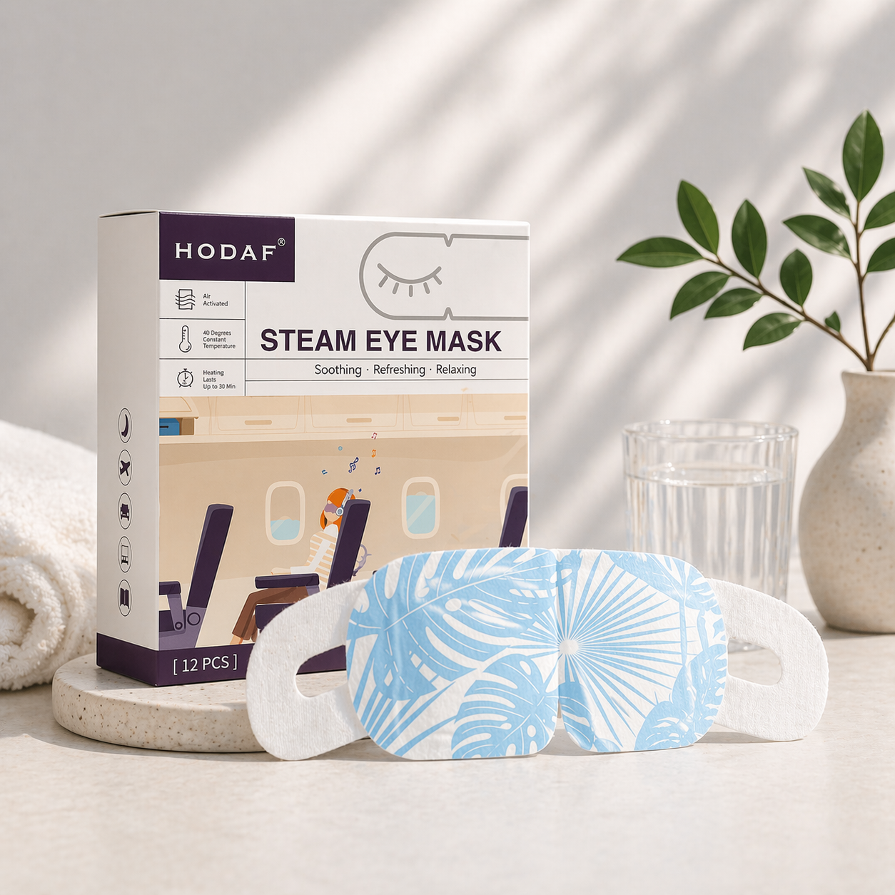 Unscented steam eye mask with product box in bright clean setting with glass of water and natural light