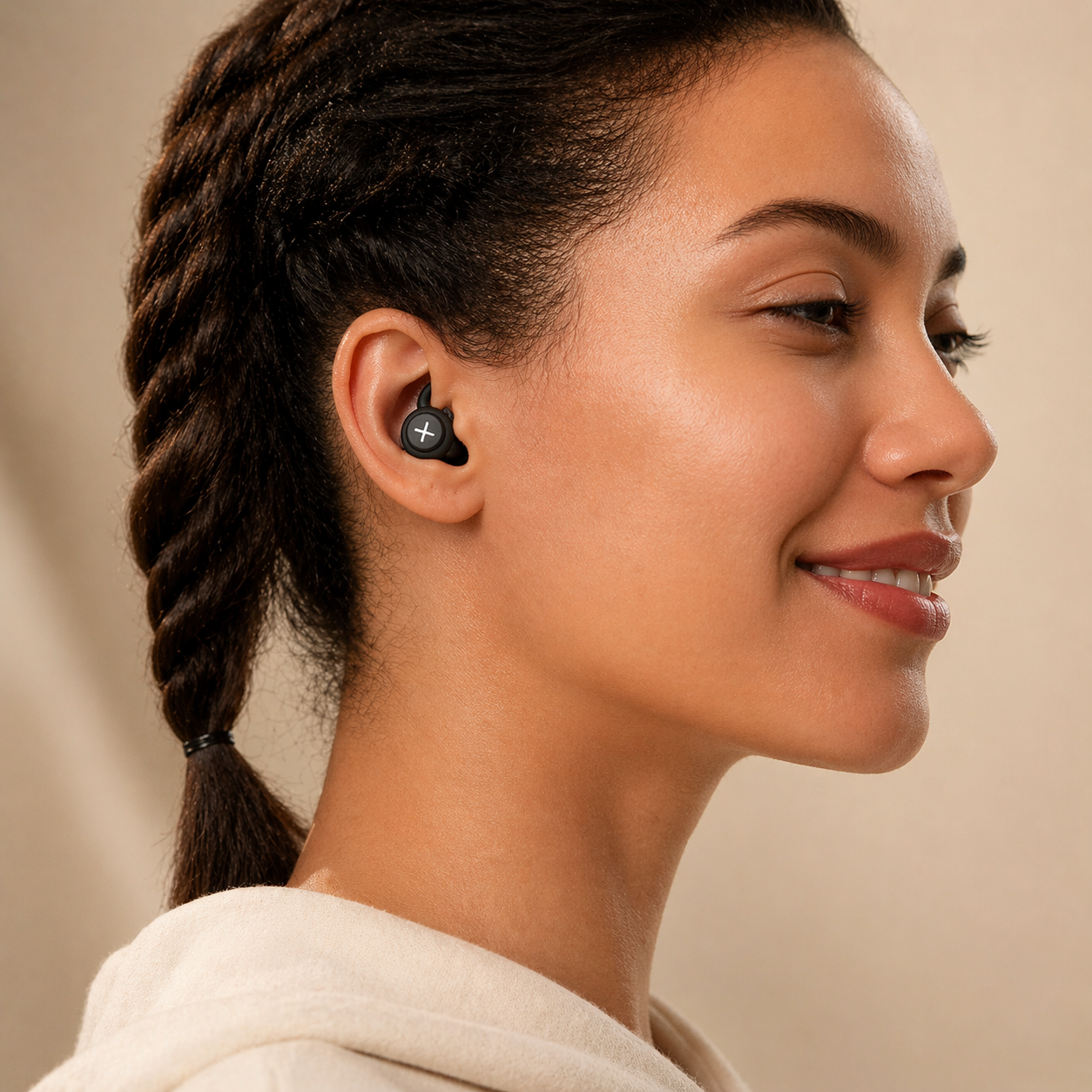 Woman wearing wireless sleep earbud demonstrating secure and comfortable in-ear fit for daily use and rest