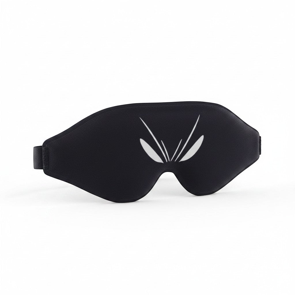SlumberHush DeepShield black contoured sleep mask with white abstract eye design and adjustable strap.