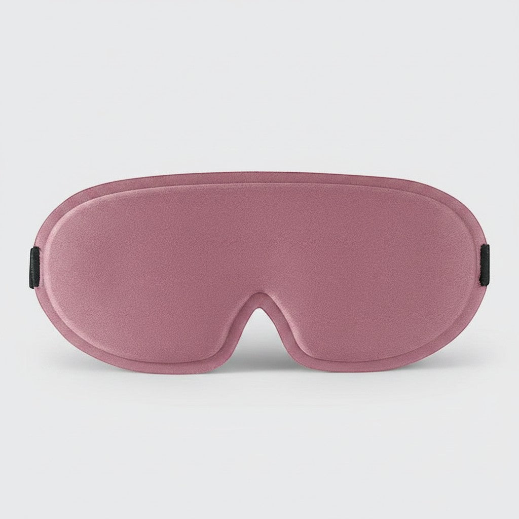 SlumberHush DeepShield sleep mask in dusty rose, contoured for comfort and light blocking.