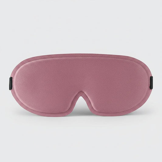 SlumberHush DeepShield sleep mask in dusty rose, contoured for comfort and light blocking.