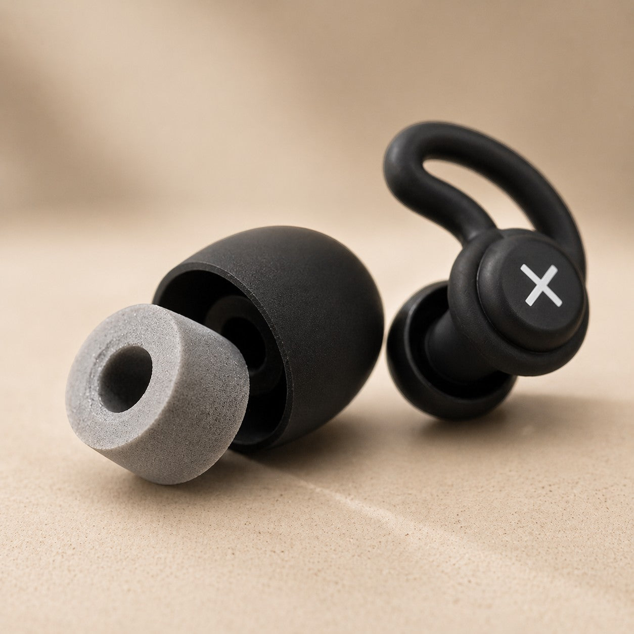 SlumberHush QuietSeal earplugs with foam tips and ear hooks. Black and grey.