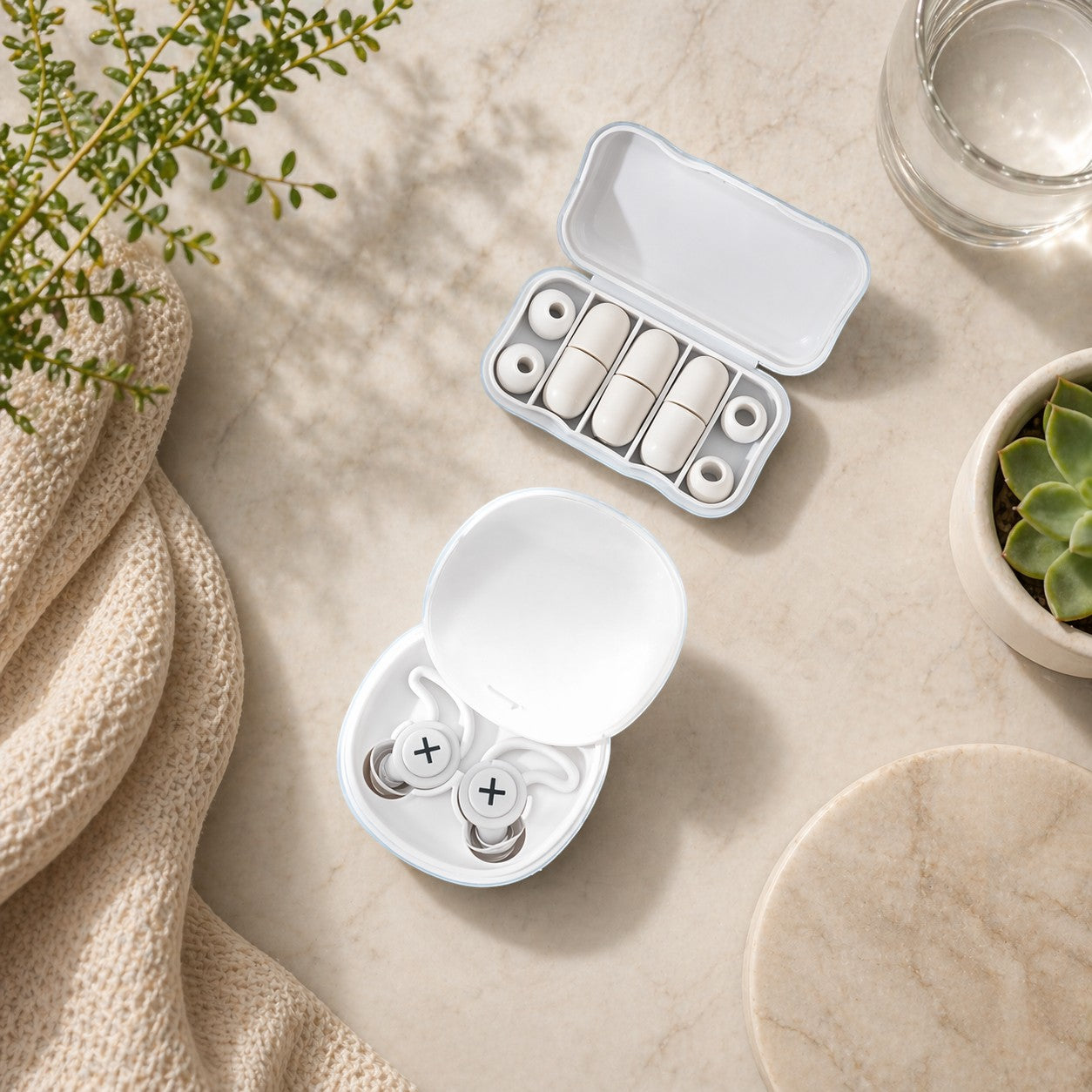SlumberHush QuietSeal earplugs in white, with a charging case and spare ear tips.