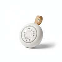 SlumberHush SoundCore baby sleep machine, white, portable with tan loop and speaker grille.