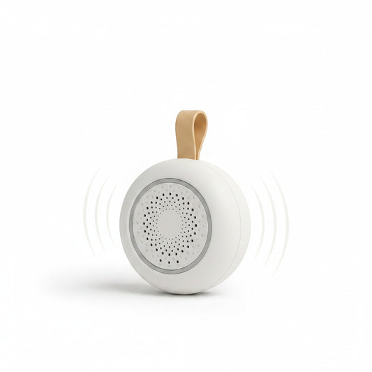 SlumberHush SoundCore baby sleep machine, white, portable, with tan loop and sound wave graphic.