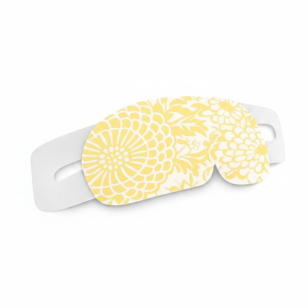 SlumberHush WarmEye steam mask with yellow floral pattern and white elastic strap
